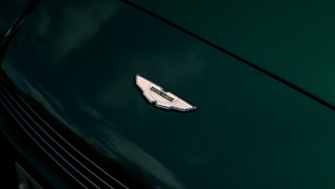 Aston Martin winged badge on a deep green bonnet
