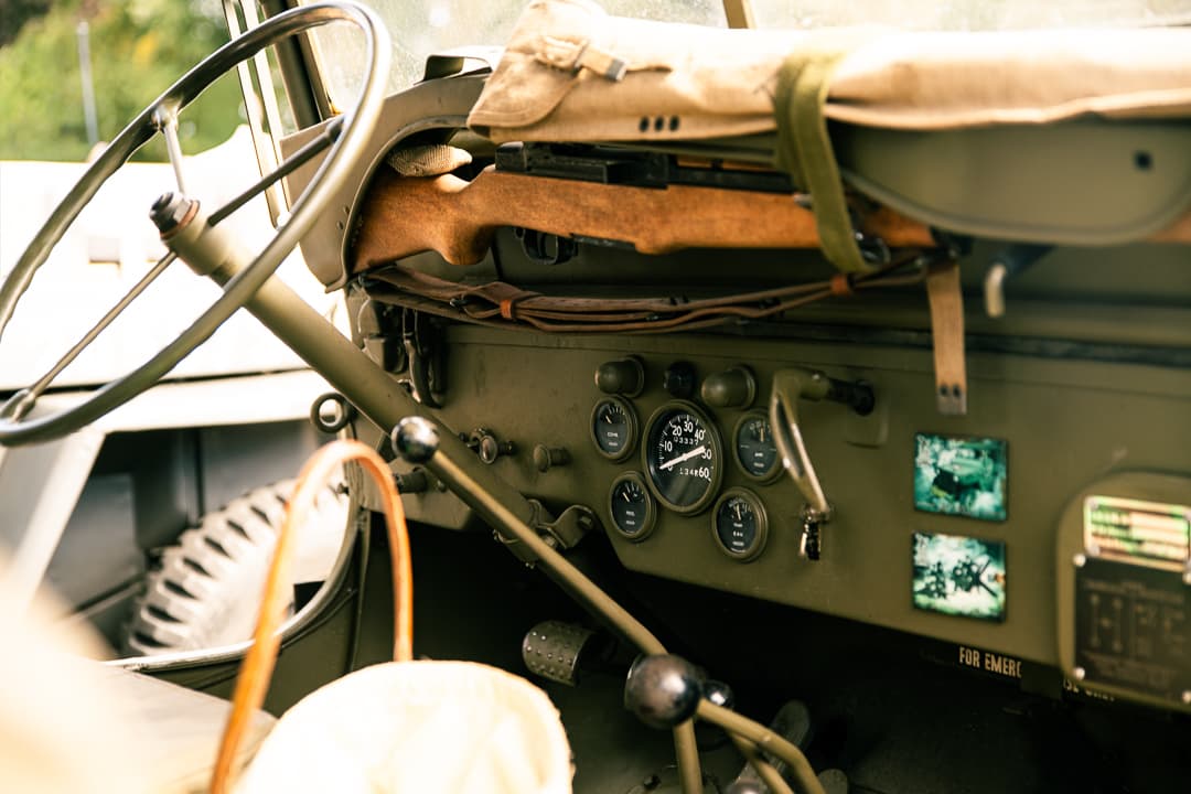 Dashboard, gauges and controls inside a canvas-topped military vehicle