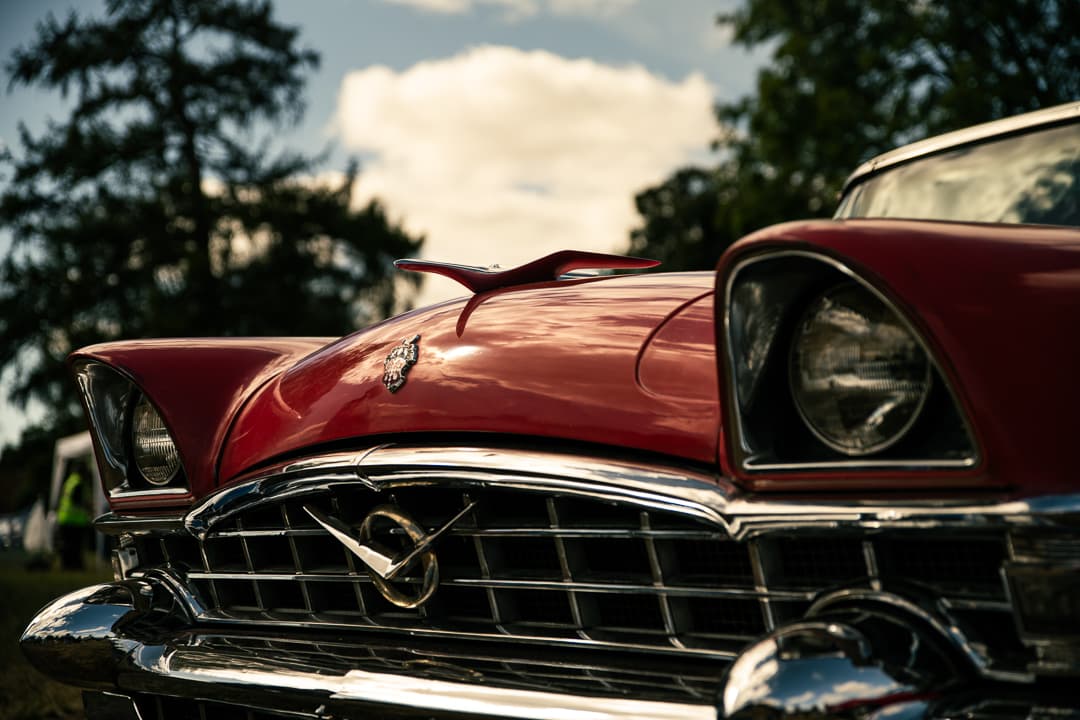 Chrome grille and bonnet ornament on a red 1950s American saloon