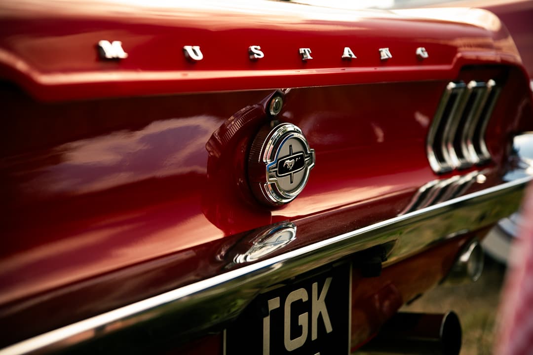 Mustang lettering and fuel cap badge on the rear of a red Ford Mustang