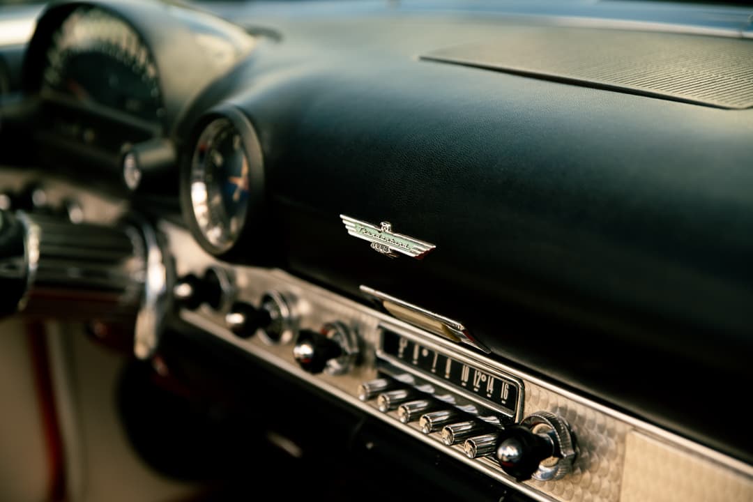 Winged Thunderbird badge and chrome radio on a Ford Thunderbird dashboard