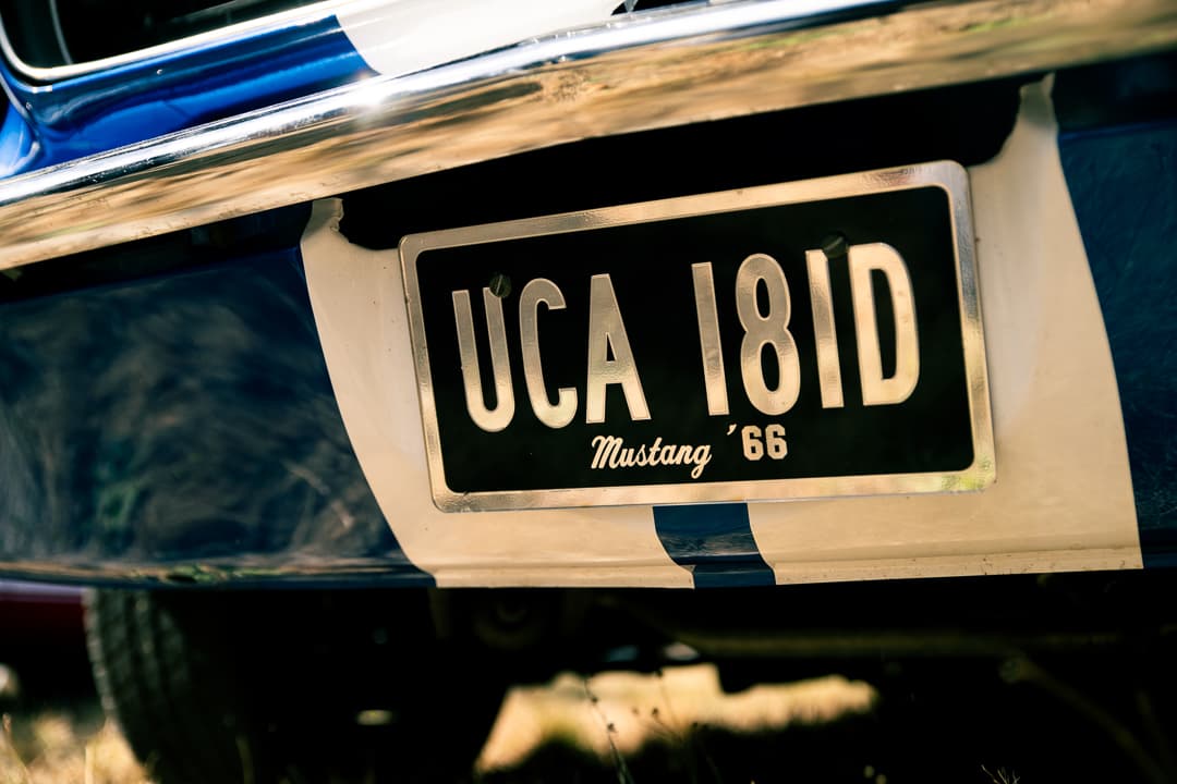 Number plate and Mustang script on the rear of a blue 1966 Ford Mustang