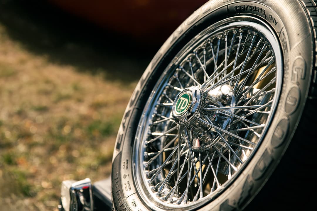 Chrome wire wheel and lettered tyre on a classic sports car
