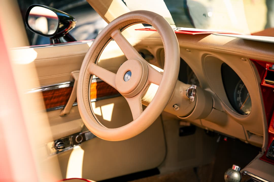 Ivory steering wheel and cream dashboard of a classic roadster