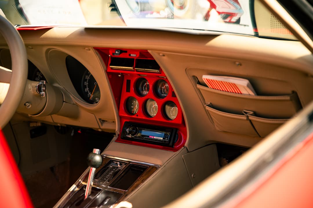 Centre console gauges and tan interior of a Chevrolet Corvette