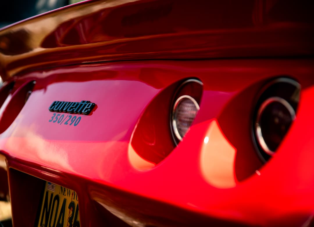 Corvette badge and round rear lights on a red Chevrolet Corvette