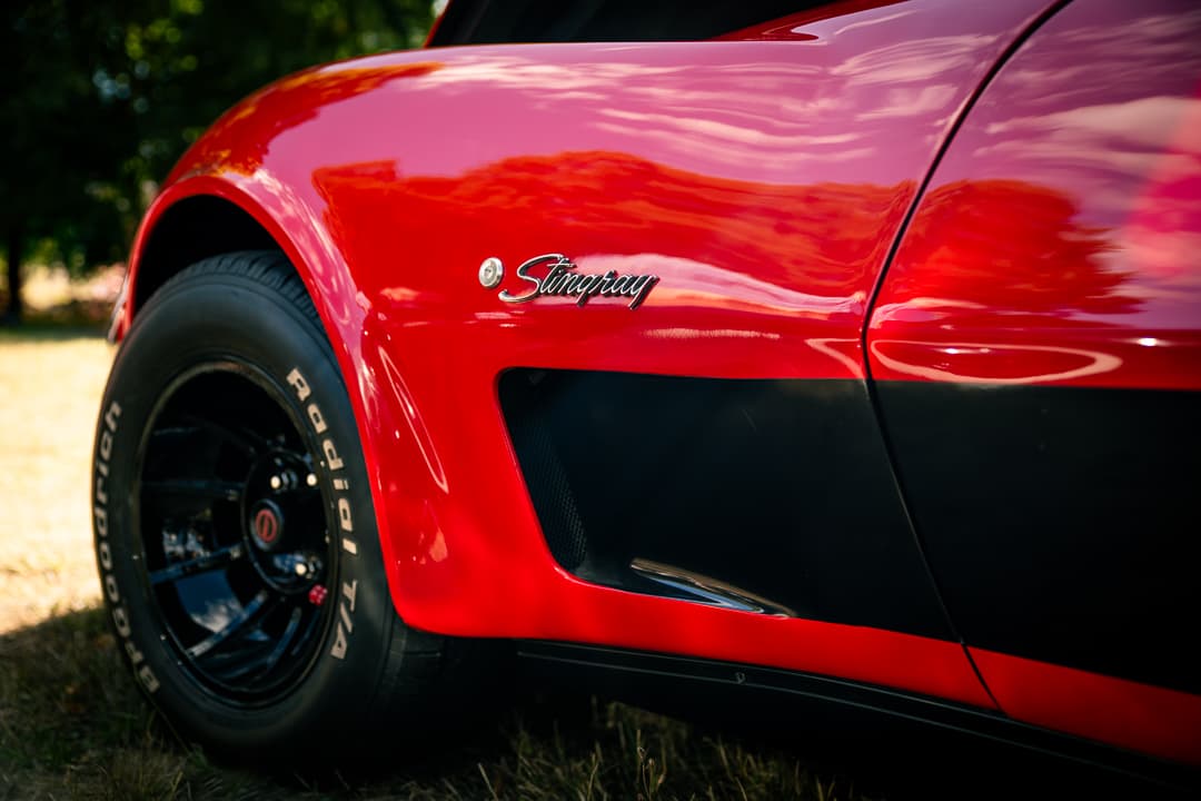 Stingray badge and wheel arch on a red Chevrolet Corvette
