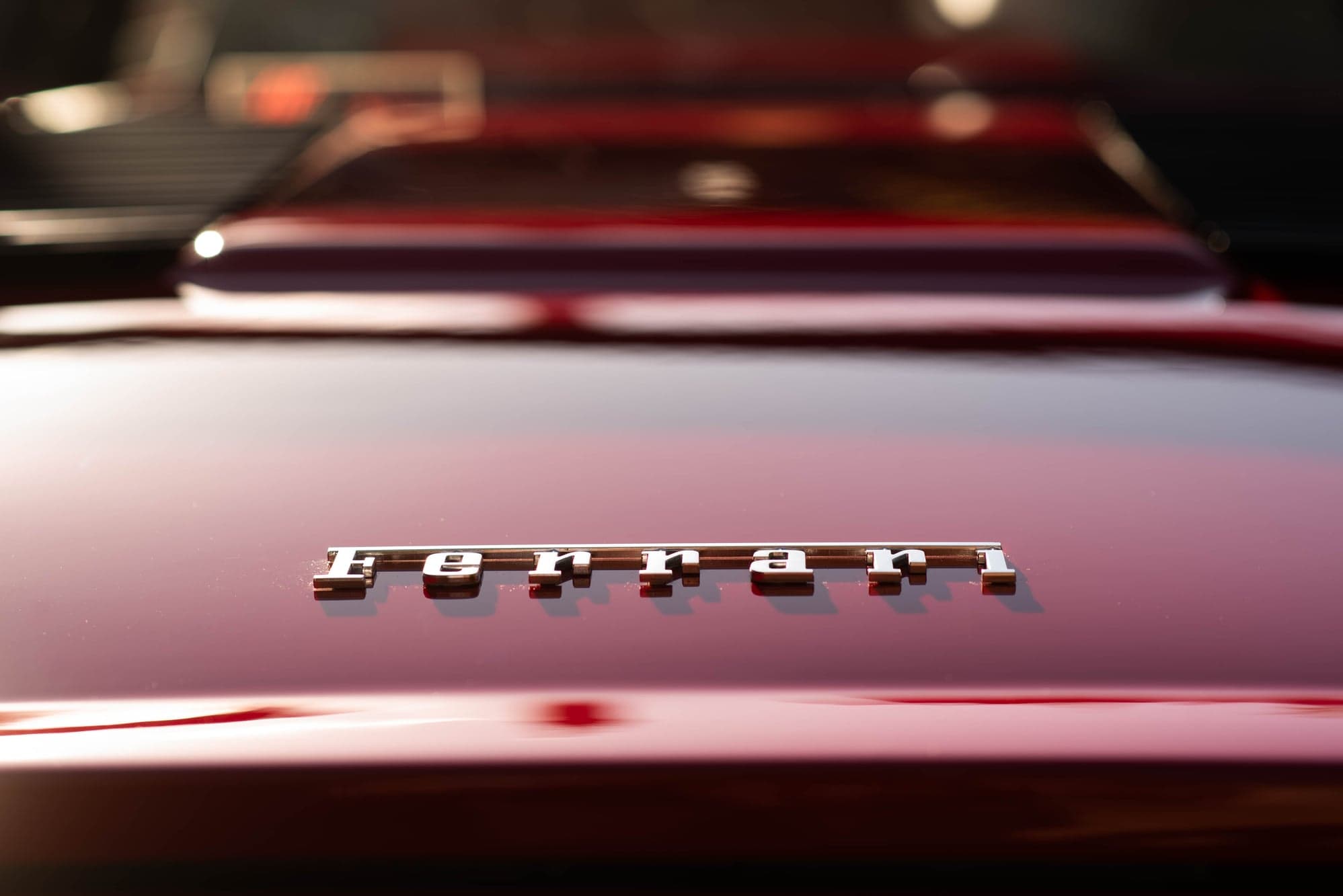 Chrome Ferrari script on the rear deck of a red 308