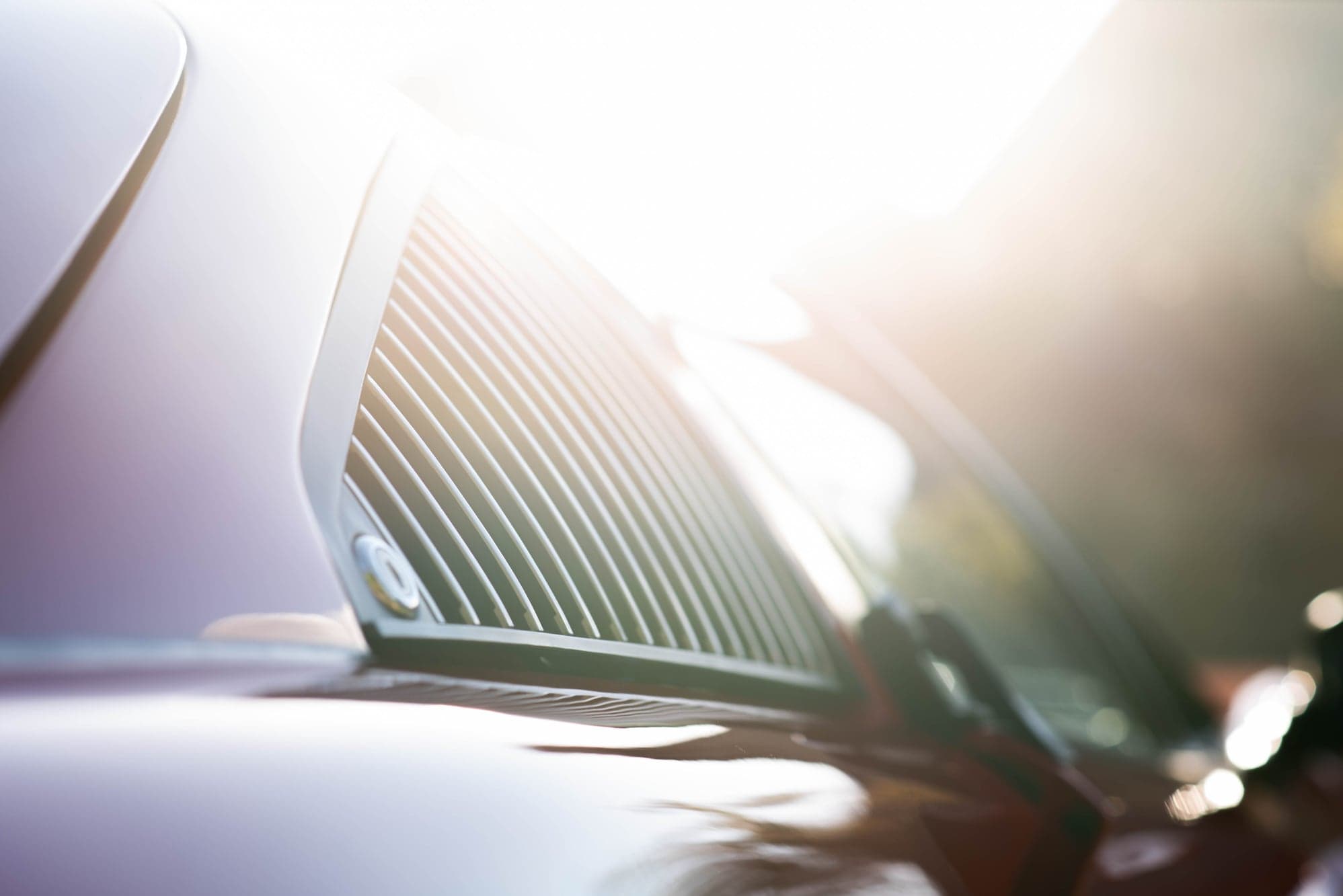Sunlight flaring through the louvred rear window of a Ferrari 308