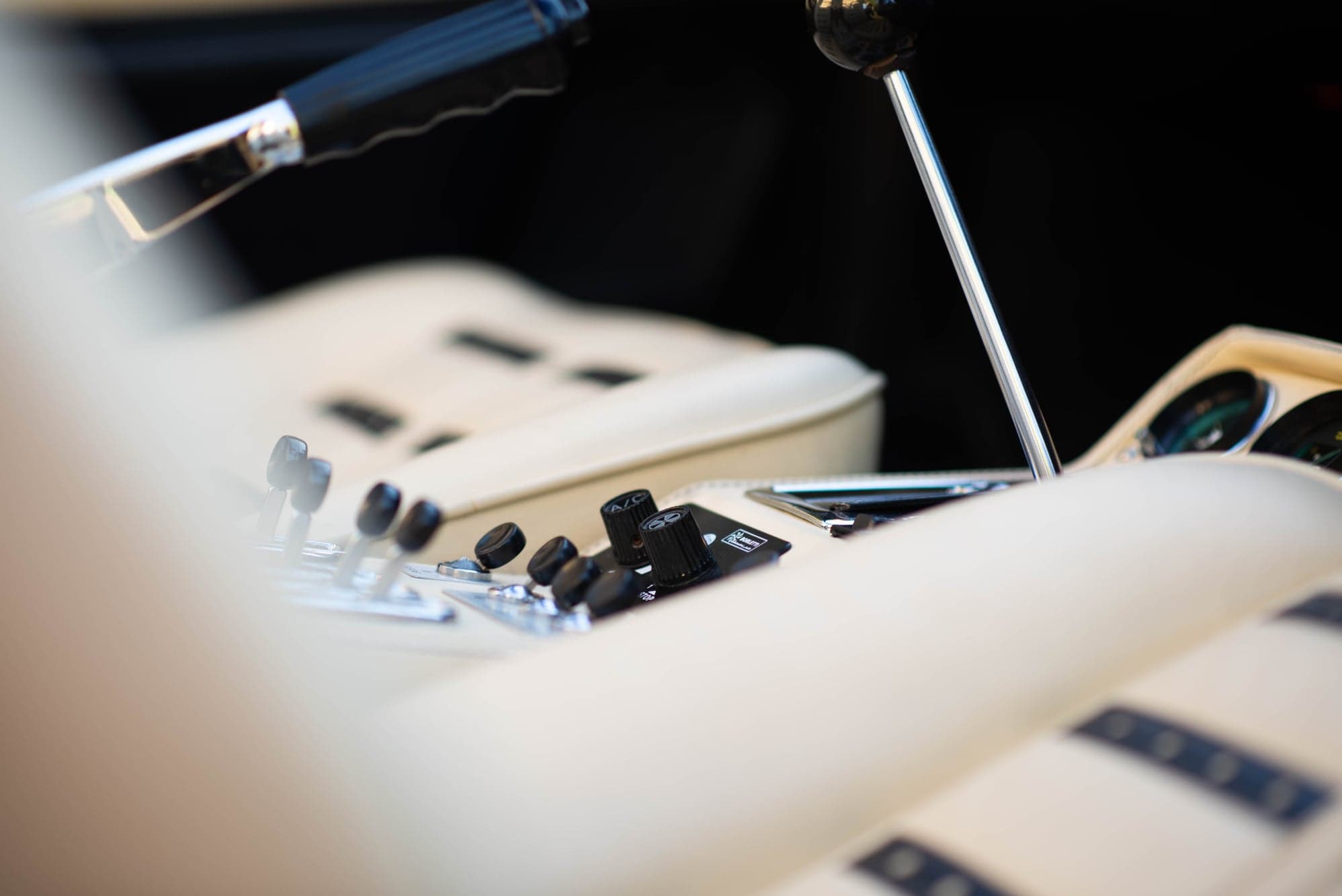 Rocker switches and open gear gate on the cream centre console of a Ferrari 308