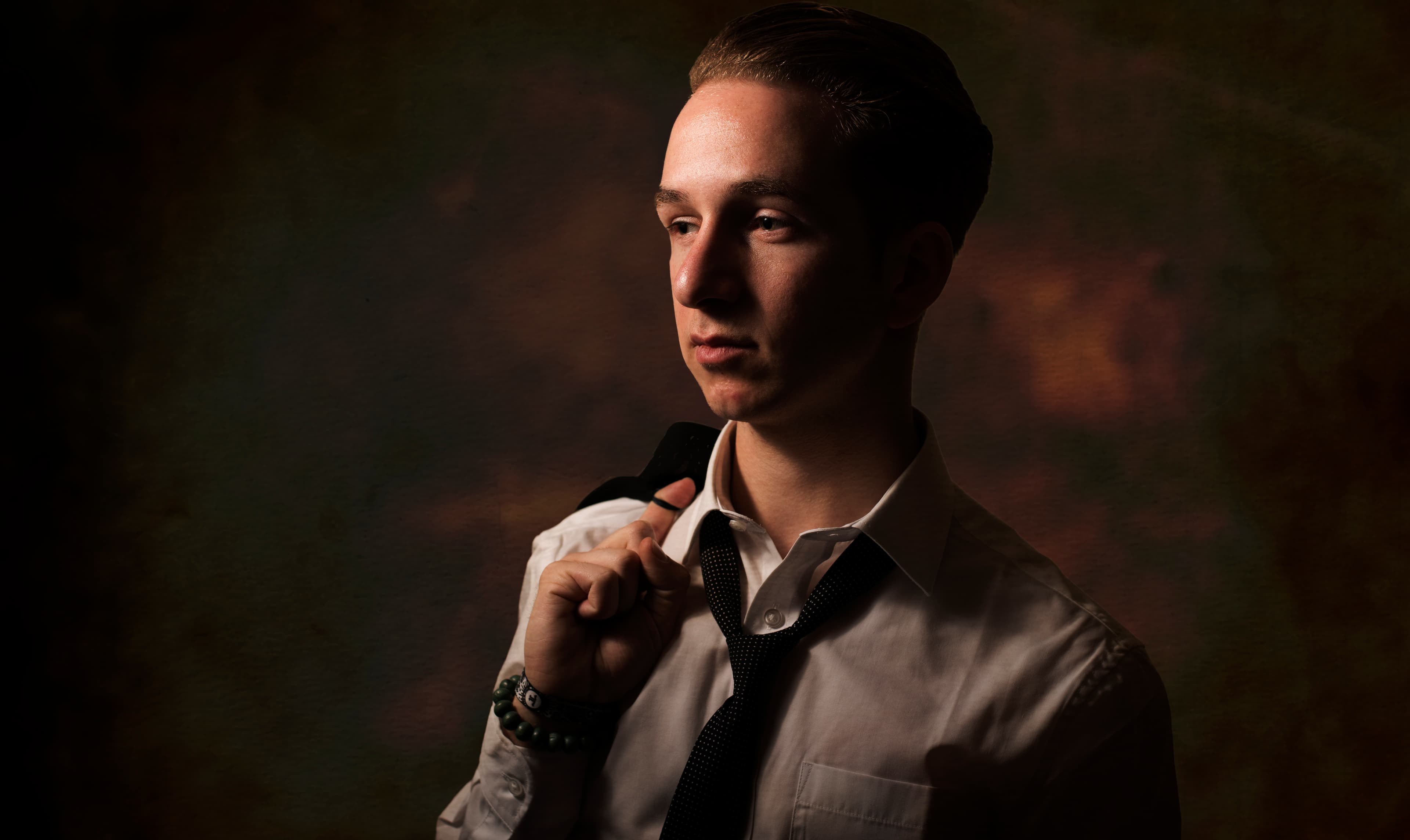 Model gazing into the distance in a dim, gloomy room