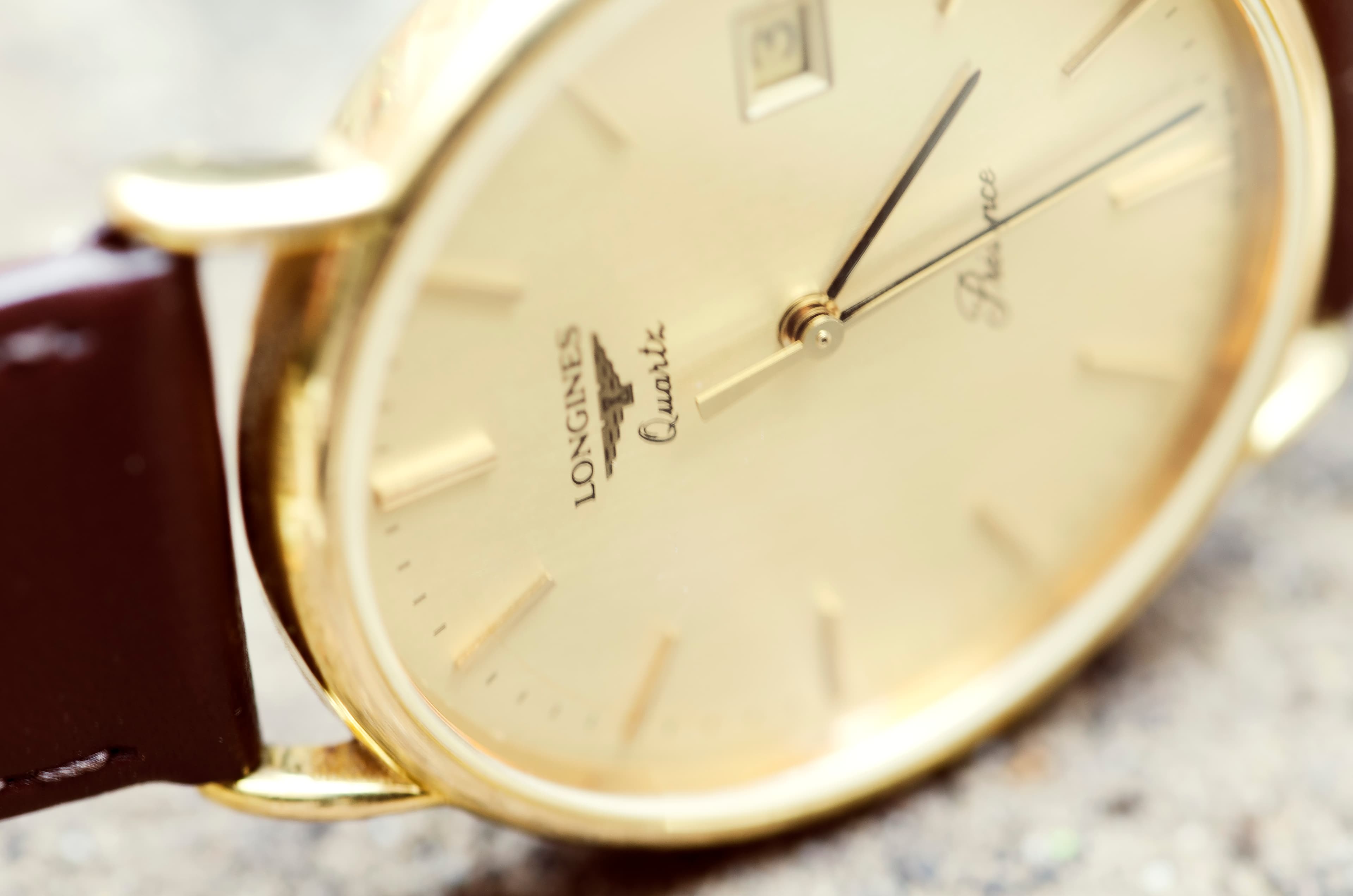 Vintage golden Longines watch with brown strap