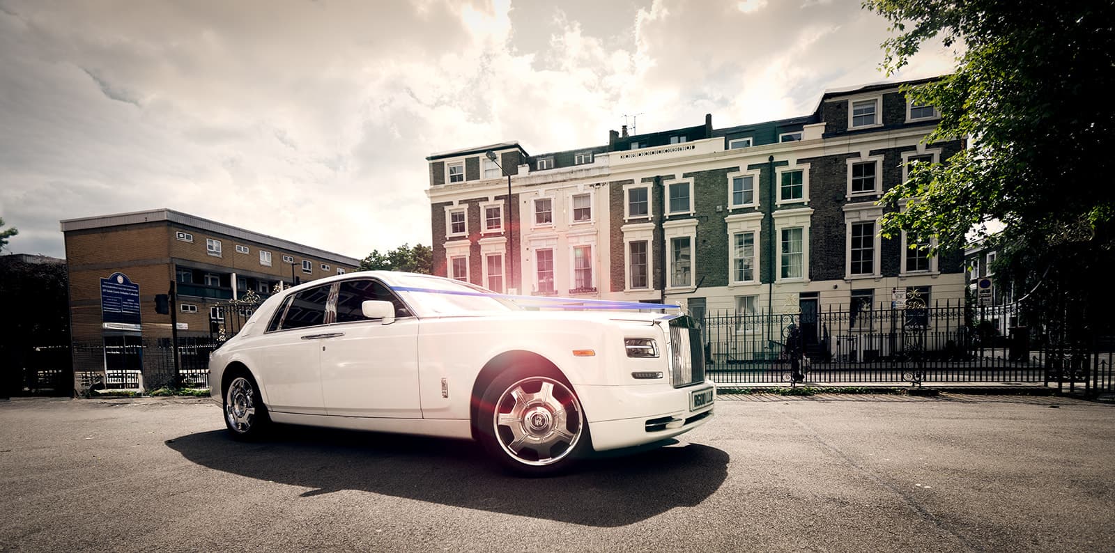 A Rolls Royce enters the wedding venue with the bride and groom