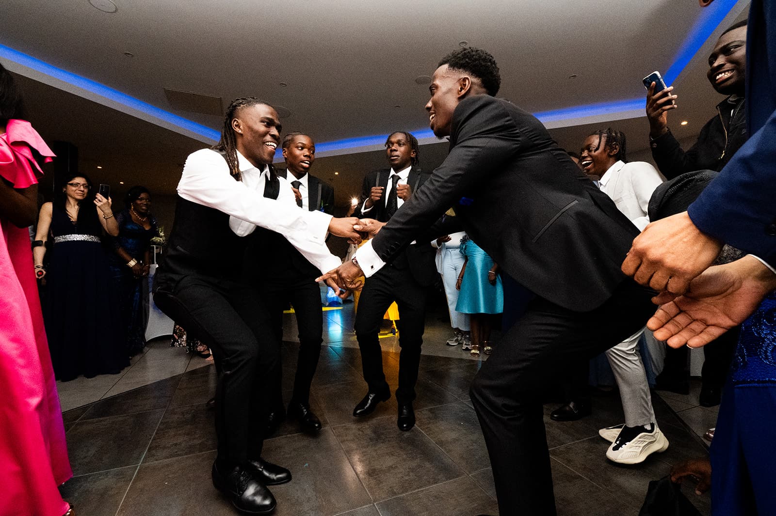 Energy on the dance floor as the groom and his groomsmen dance