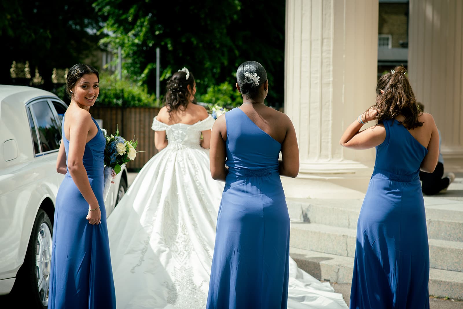 The bride arrives at the church with her bridesmaids